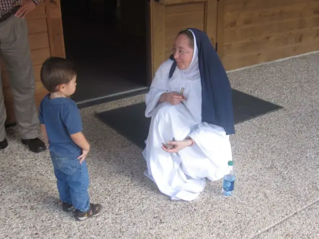 Sister Ampola meets one of our young visitors to the Divine Mercy Center