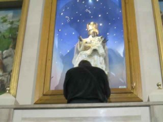 Praying before the image in the Shrine of BVM Mother of God Crowned in Foggia