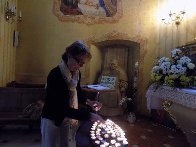 Lighting a candle at the church where St. John Paul II was baptized