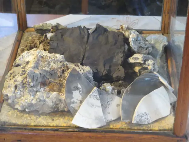artifacts from the great Peshtigo fire..the blackened object is a bible petrified from the heat
