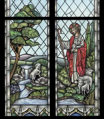 The Good Shepherd Stained glass window in the Cathedral of Our Lady of Walsingham in Houston, Texas